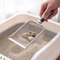 Stainless steel cat litter scoop being used