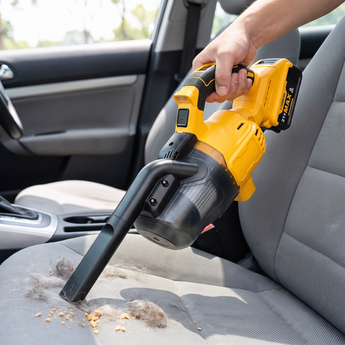 Person using a yellow cordless handheld vacuum to clean pet hair off a car seat